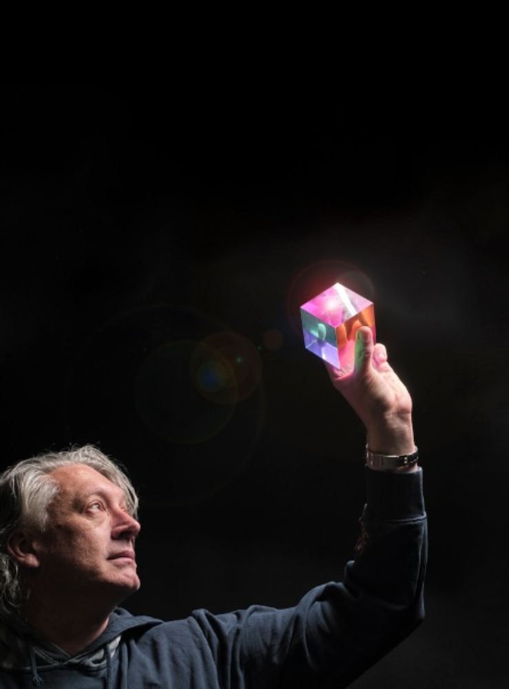 Dr Errol Brandt is holding a mulicolored cube which represents the Analytical Dataframe technology
