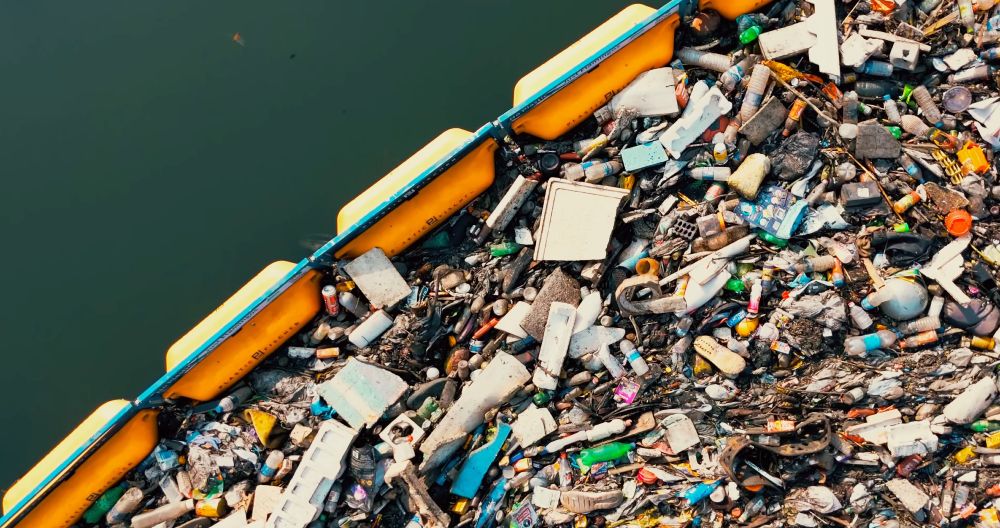 drone view on Plastic Fischer TrashBoom blocking waste