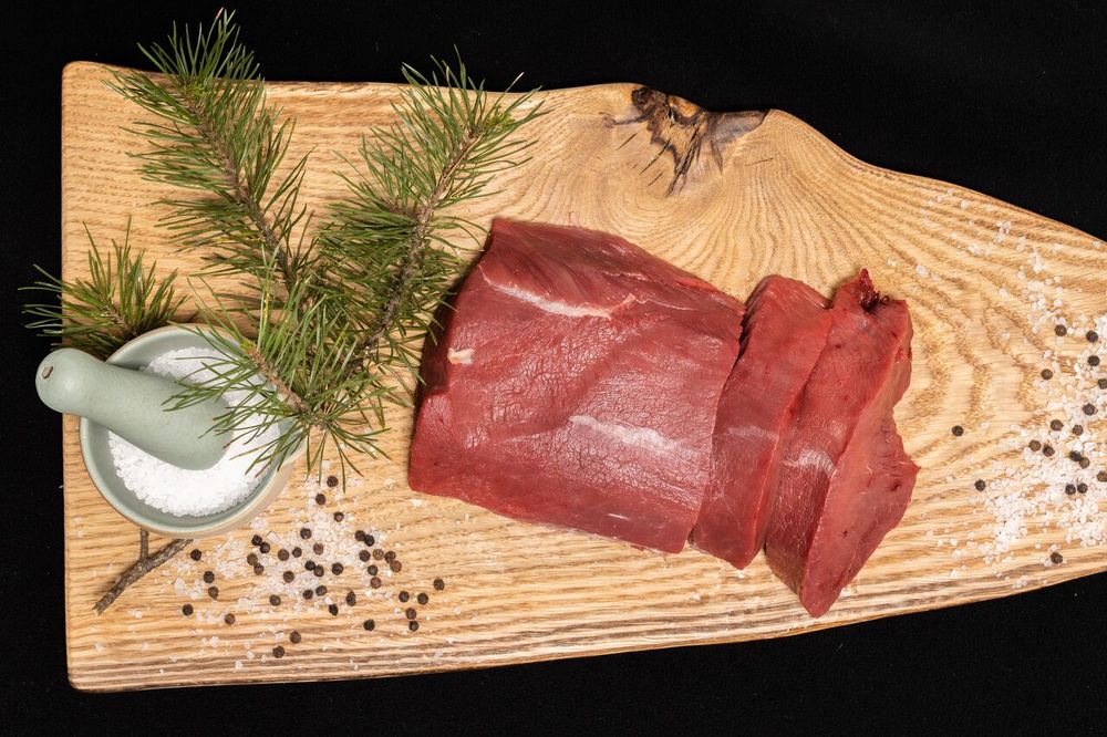 A piece of meat from a local producer on a cutting board